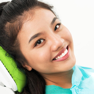Smiling girl on a dental chair