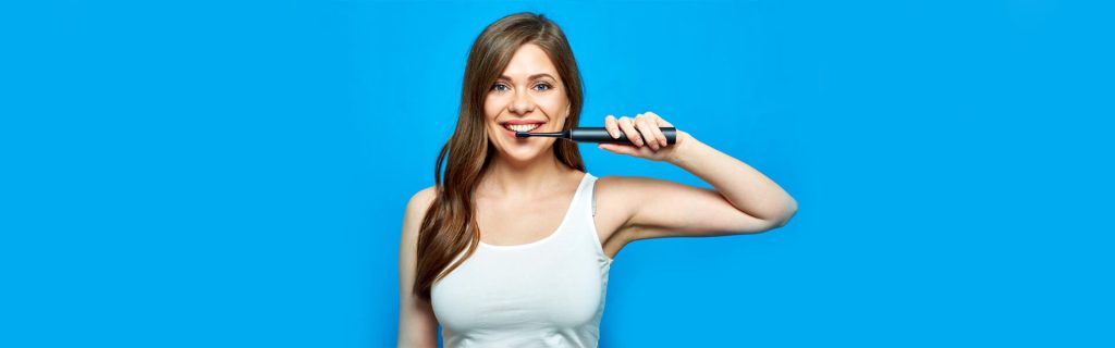 A girl having electric toothbrush in hand
